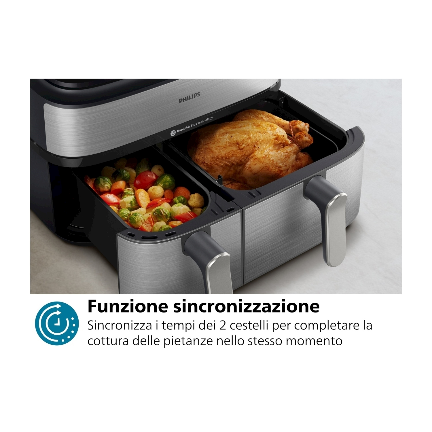 Friggitrice ad aria Philips con due scomparti. Pollo e verdure all'interno. Nero e argento.