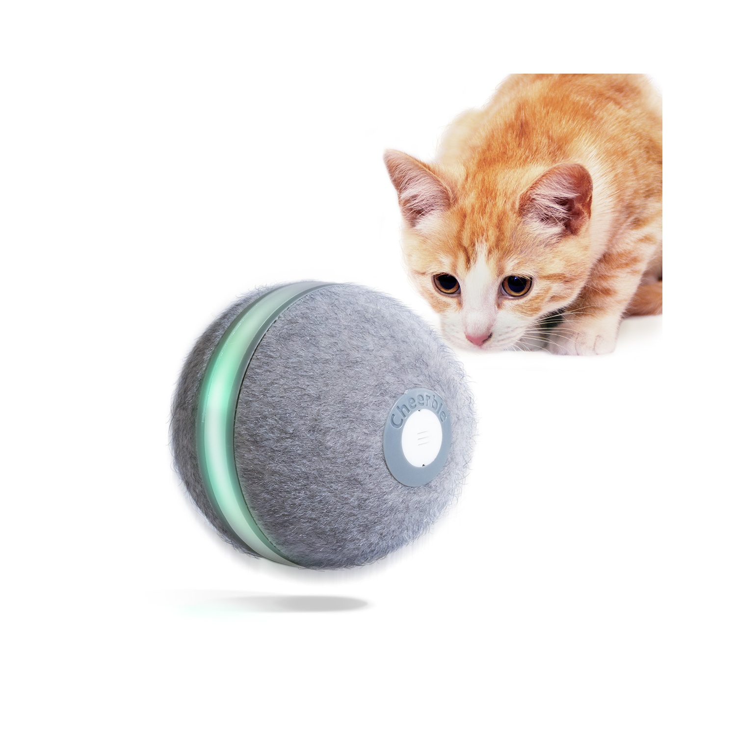 A cat looking at a grey cat toy with a green light.