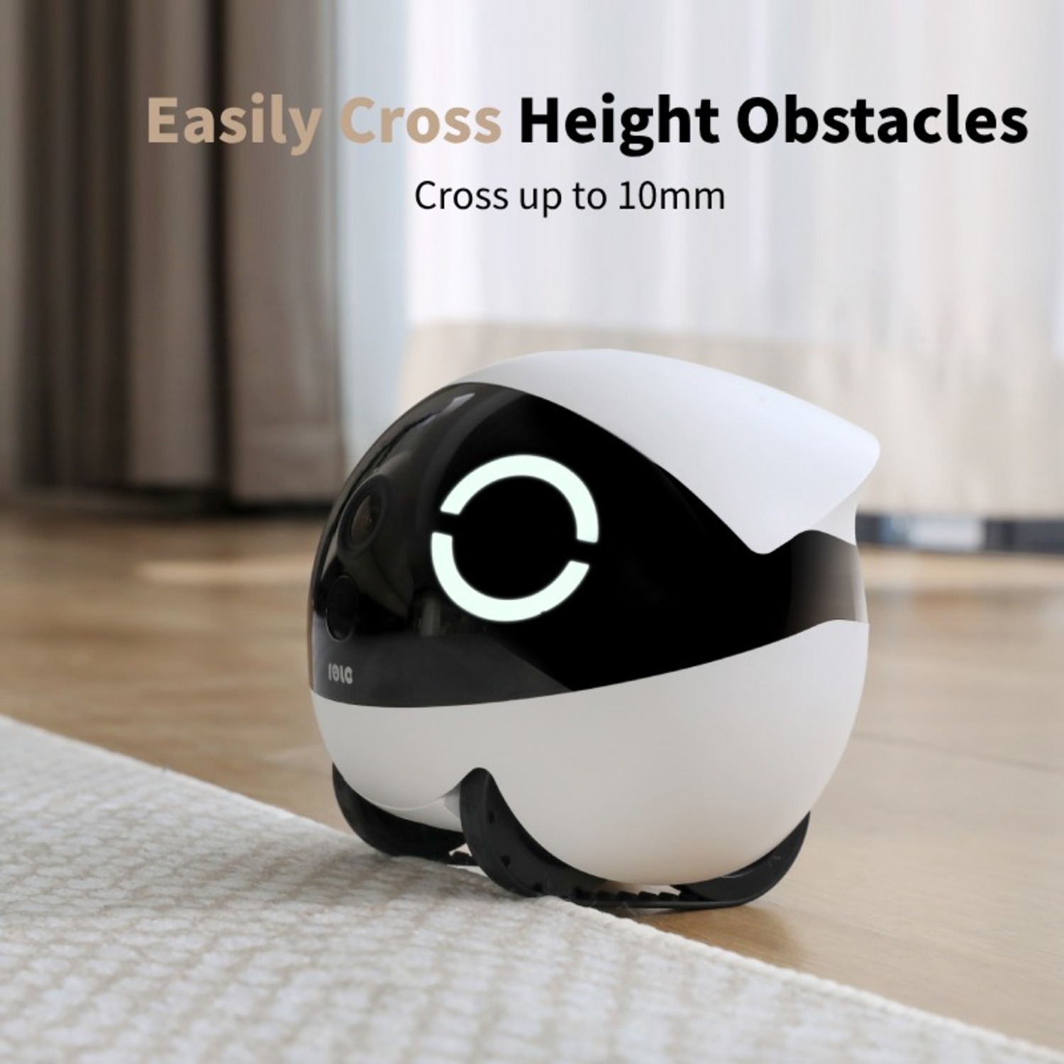 White and black robot toy. Small, round shape. On a wooden floor.