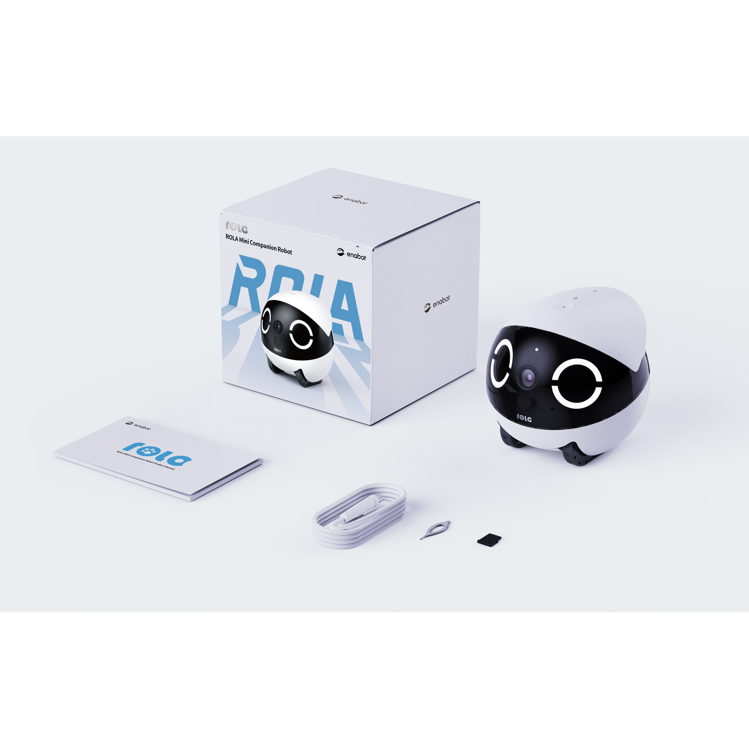 White box, a robot, and accessories on a white surface. Box says ROLA Compasion Robot.