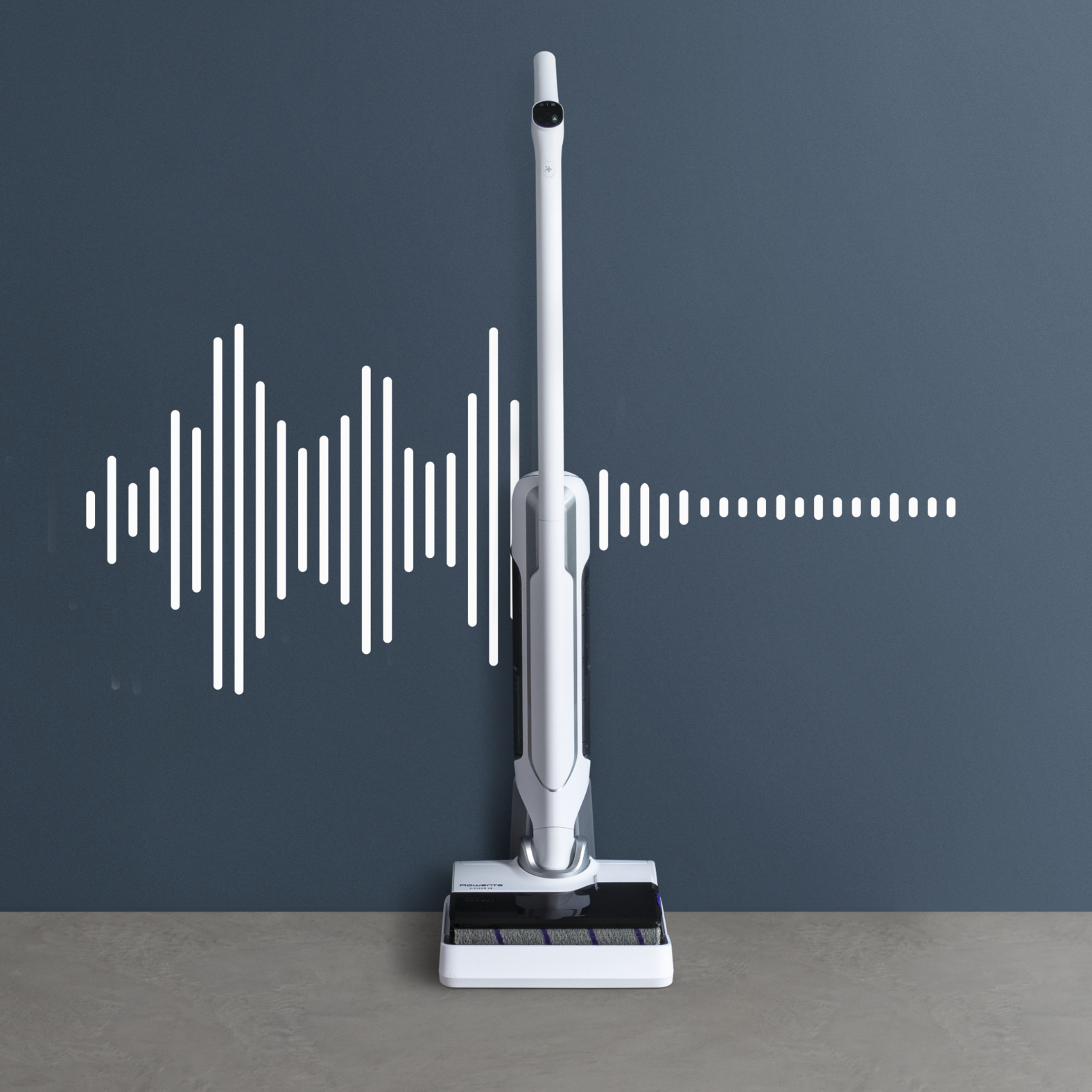 Biały odkurzacz na szarej powierzchni. Obecny wykres fali dźwiękowej.
