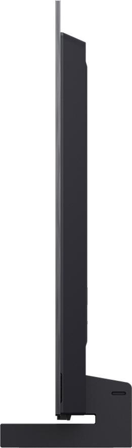 Ein schlanker schwarzer Fernseher, Seitenansicht, mit einem Ständer. Der Bildschirm ist dunkel.