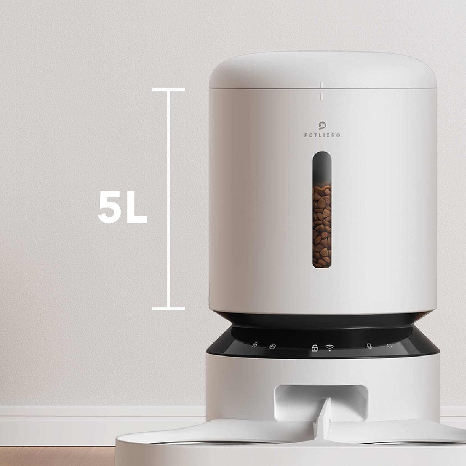A pet food dispenser. It is white with a transparent container. The capacity is indicated as 5L.
