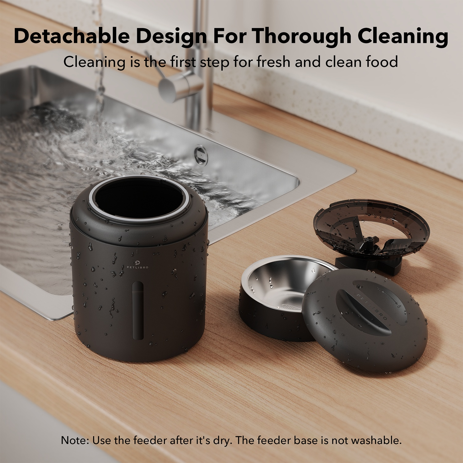 Black pet food dispenser components. Includes a container, bowl, and lid on a wooden surface.