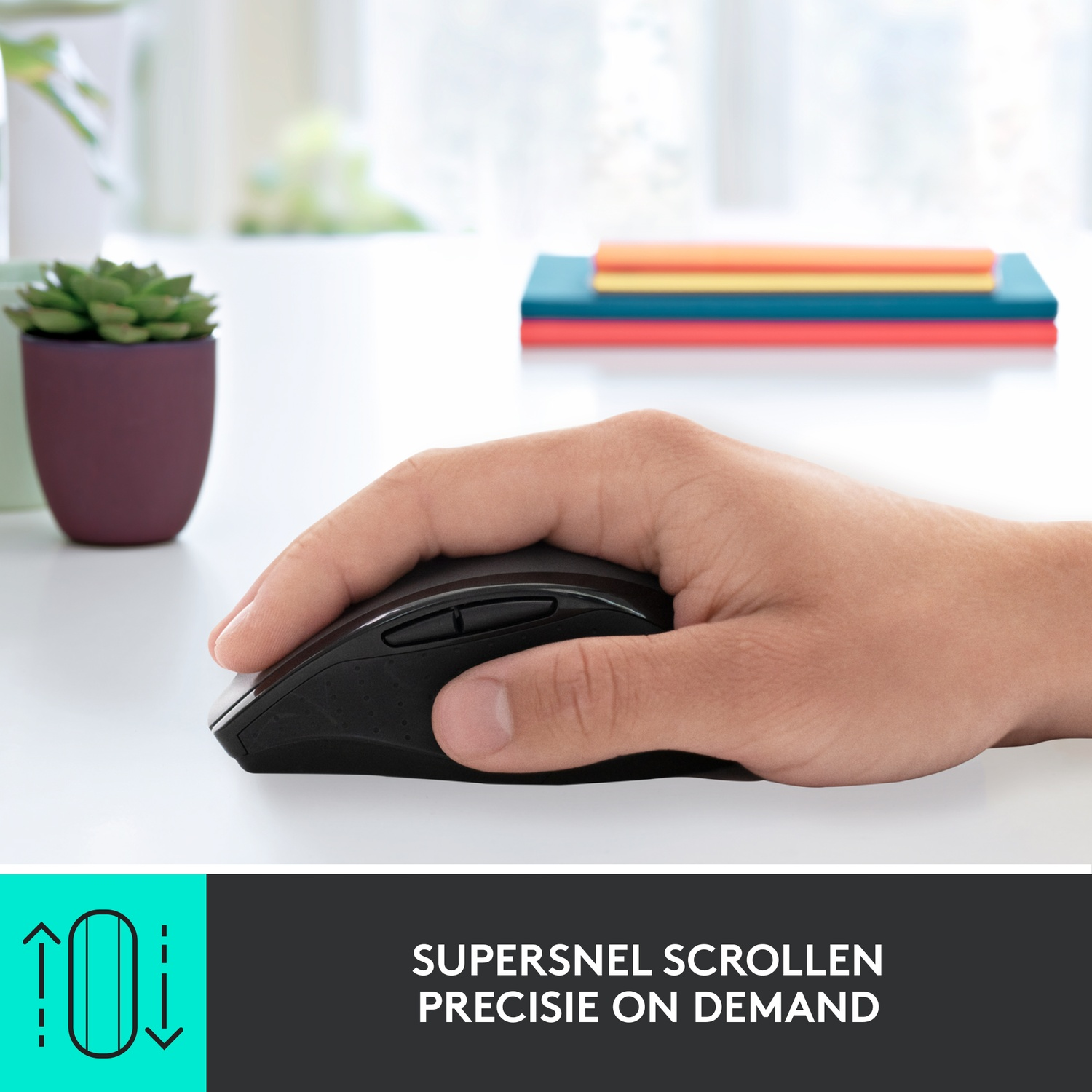 Hand holding a black mouse on a white table. Background has a succulent and colorful sticky notes.