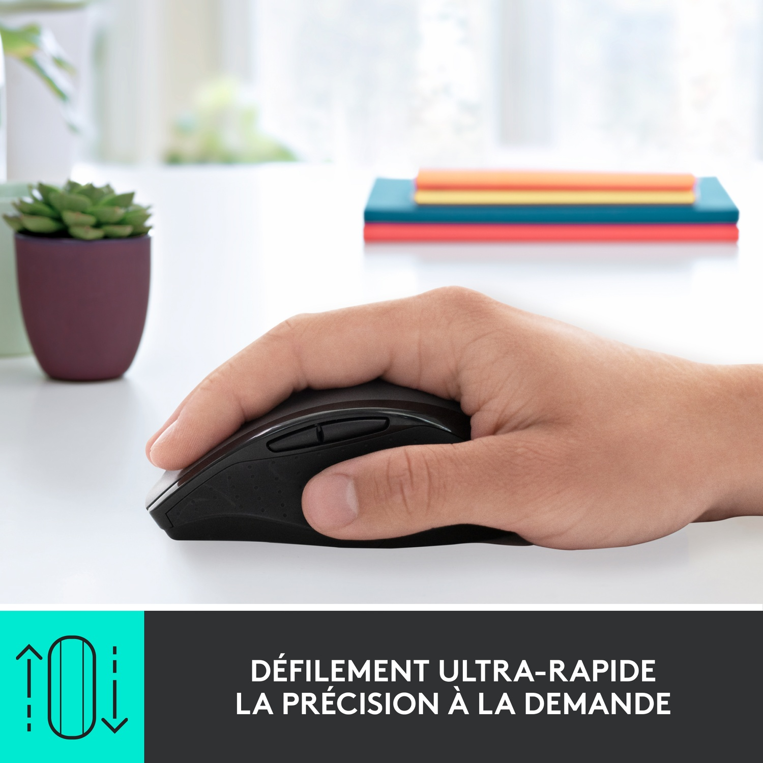 Une main tenant une souris noire sur une table blanche, avec du texte sur le défilement.