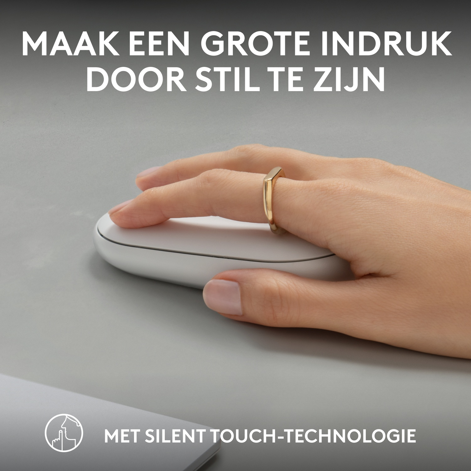 A hand wearing a gold ring touches a white mouse on a gray surface, with text about silent touch.