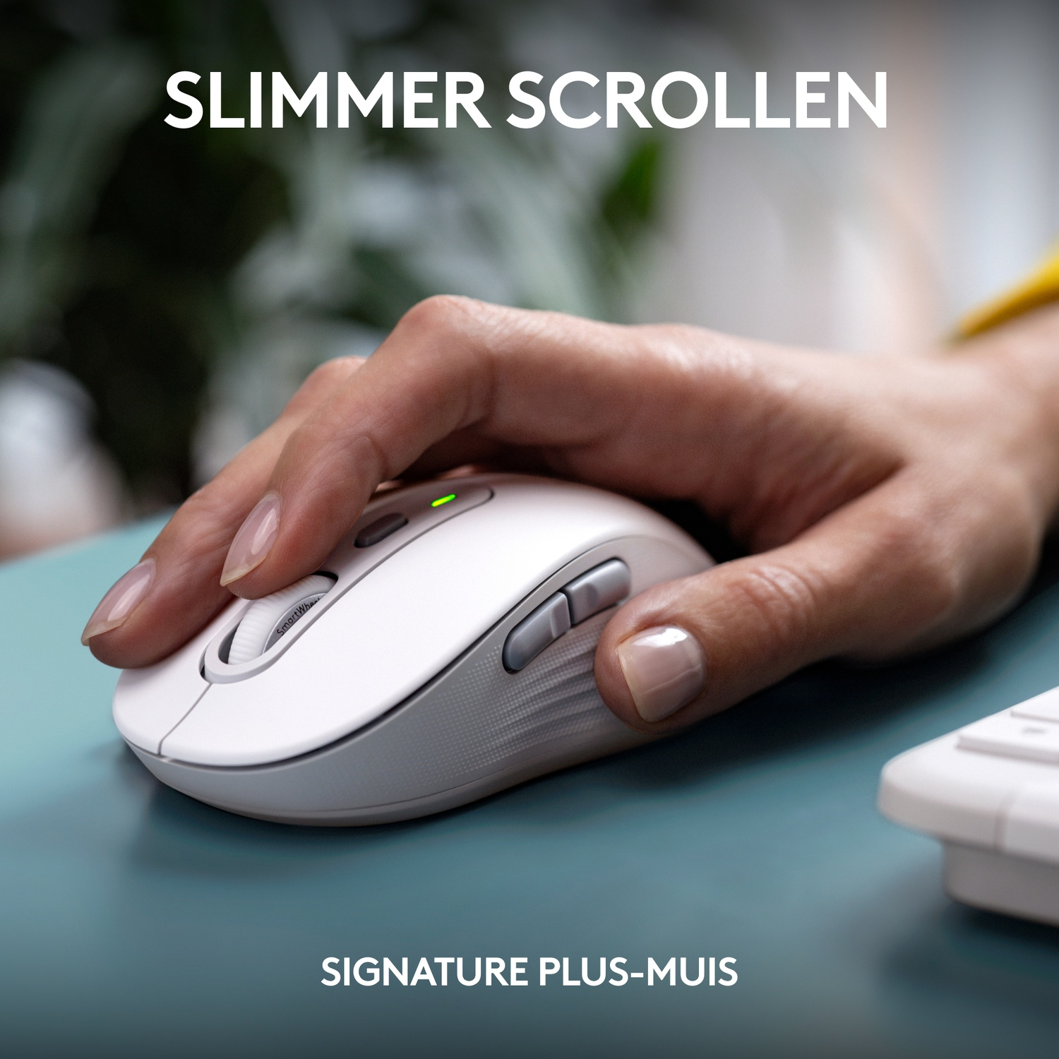 A white mouse being held by a person's hand, green light on top.
