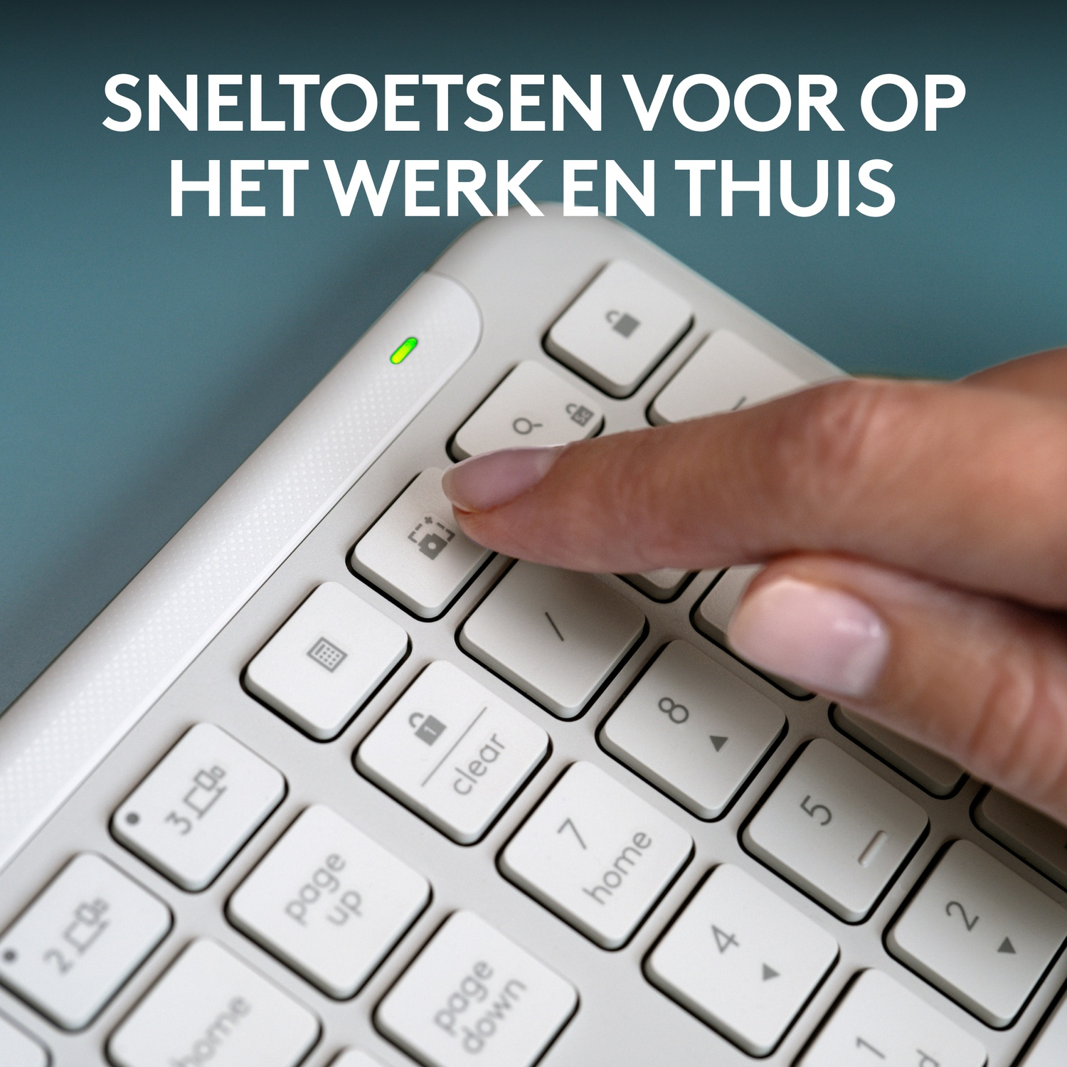 A hand pressing the lock key on a white keyboard with light green light.