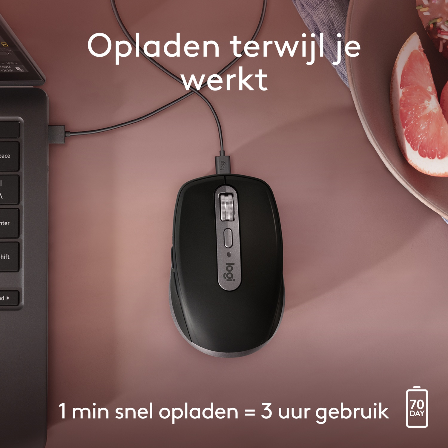 A black mouse is connected to a laptop with a charging cable.