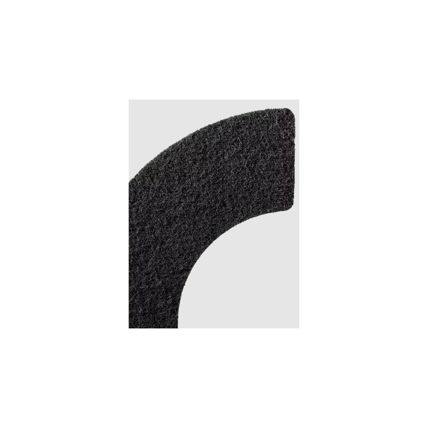 Close-up of a dark gray, curved material against a white background.