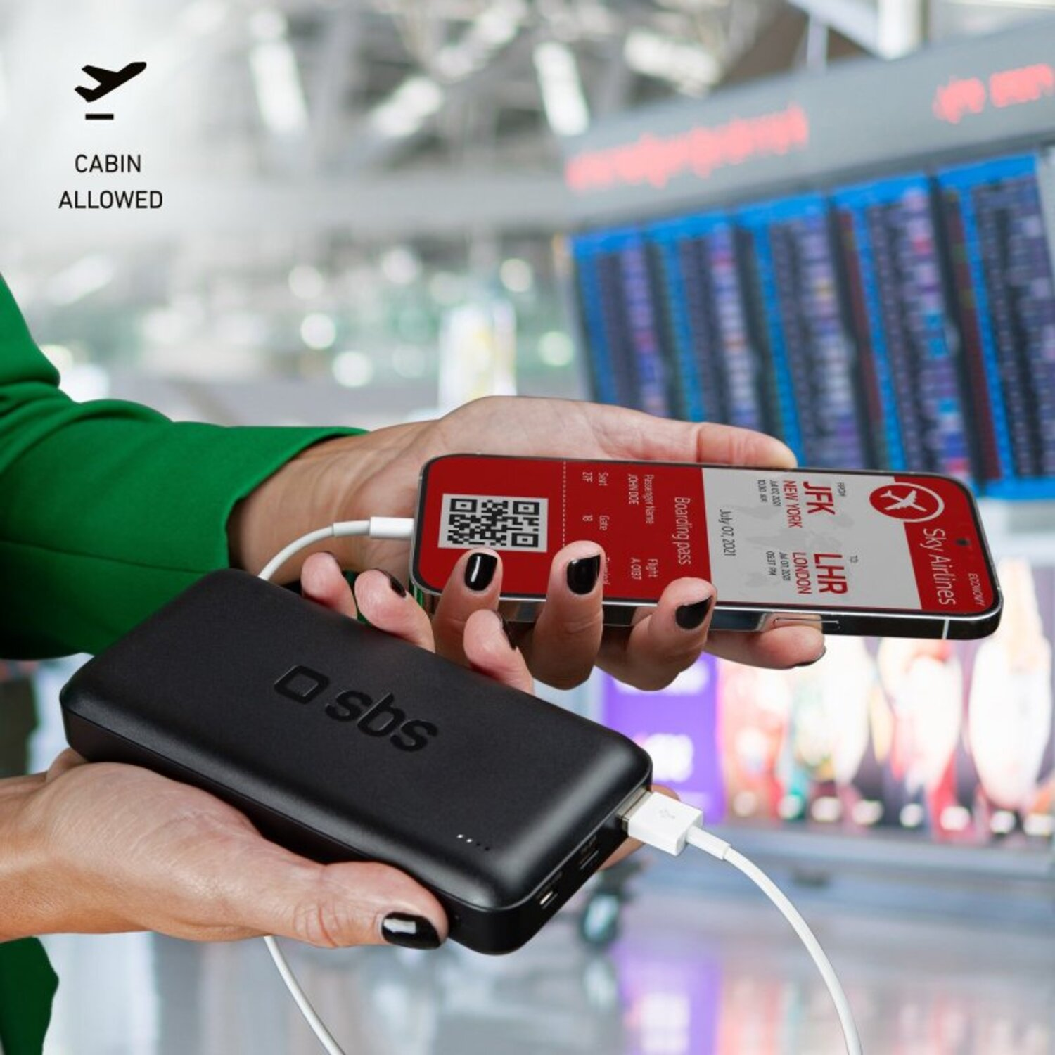A person holding a black power bank and phone with a boarding pass.
