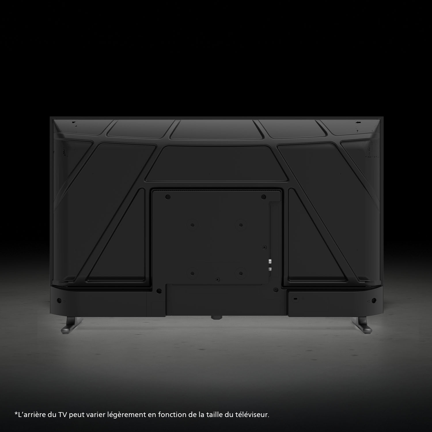 L'arrière d'une télévision noire avec un motif géométrique et un support sur une surface grise.