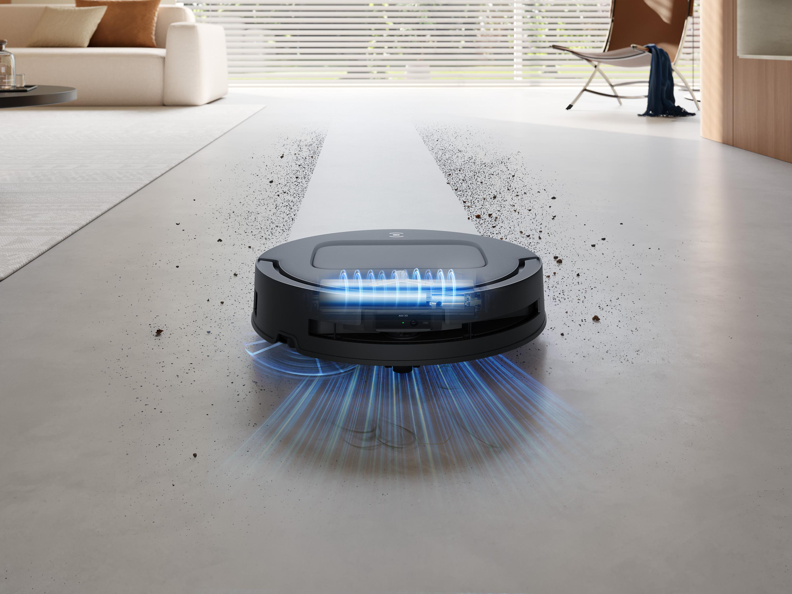 Ein schwarzer Roboter-Staubsauger bewegt sich über einen hellen Boden und hinterlässt eine saubere Spur.