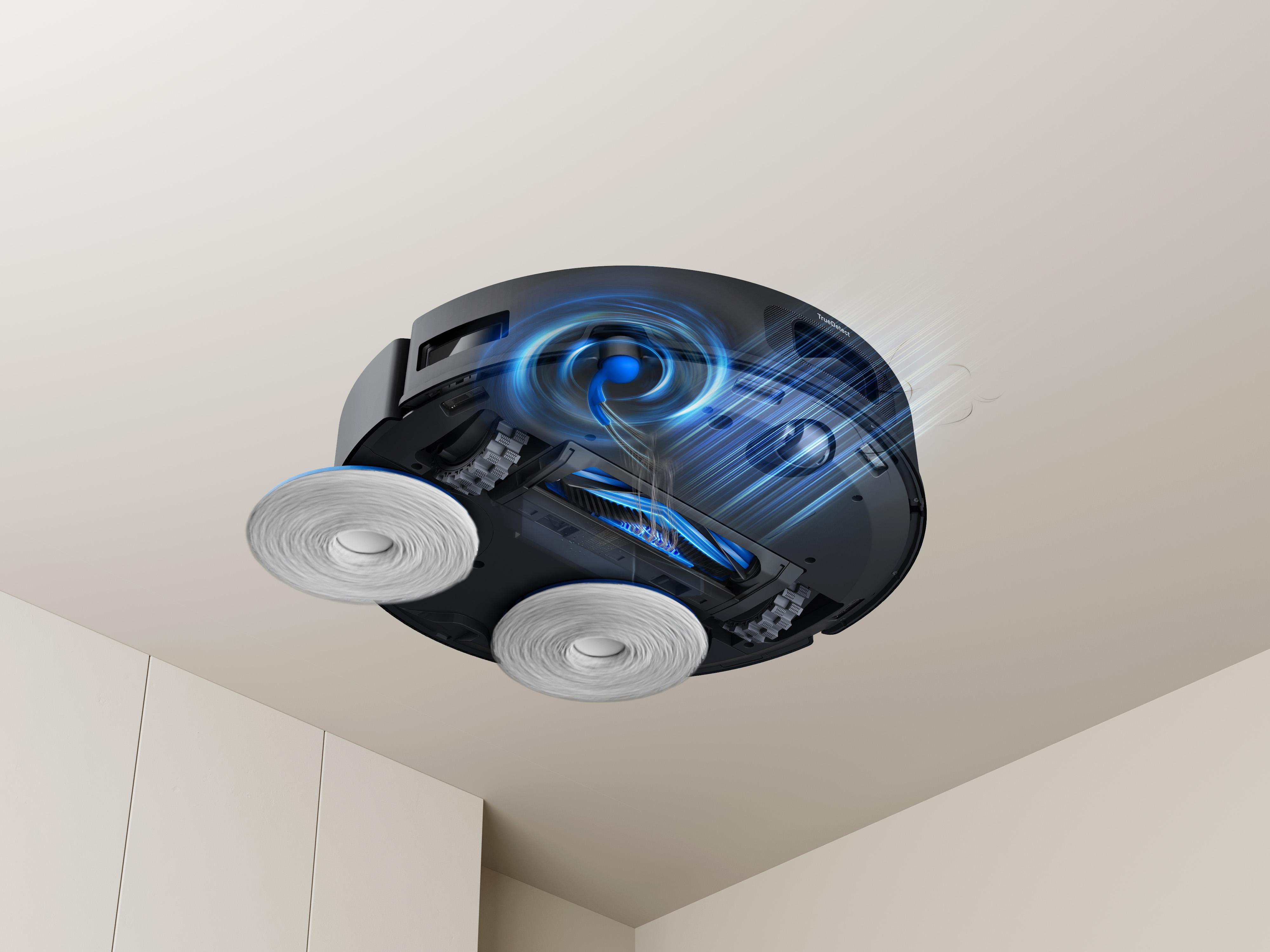 Ein Roboter-Staubsauger, kopfüber, mit Bürsten und einem wirbelnden blauen Luftstrom.