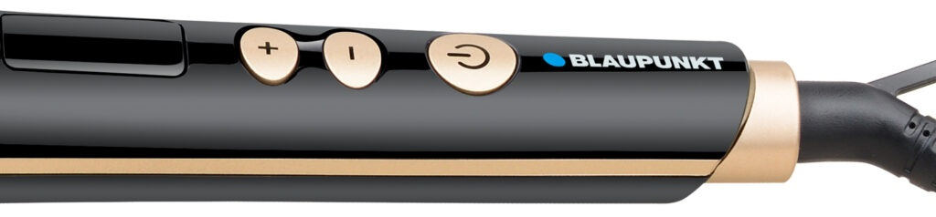 Zbliżenie czarnej i złotej lokówki z przyciskami.