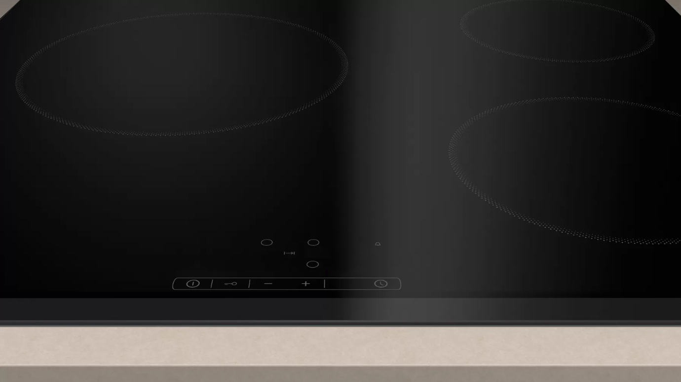 Una placa de inducción con cuatro zonas de cocción negras y un panel de control.