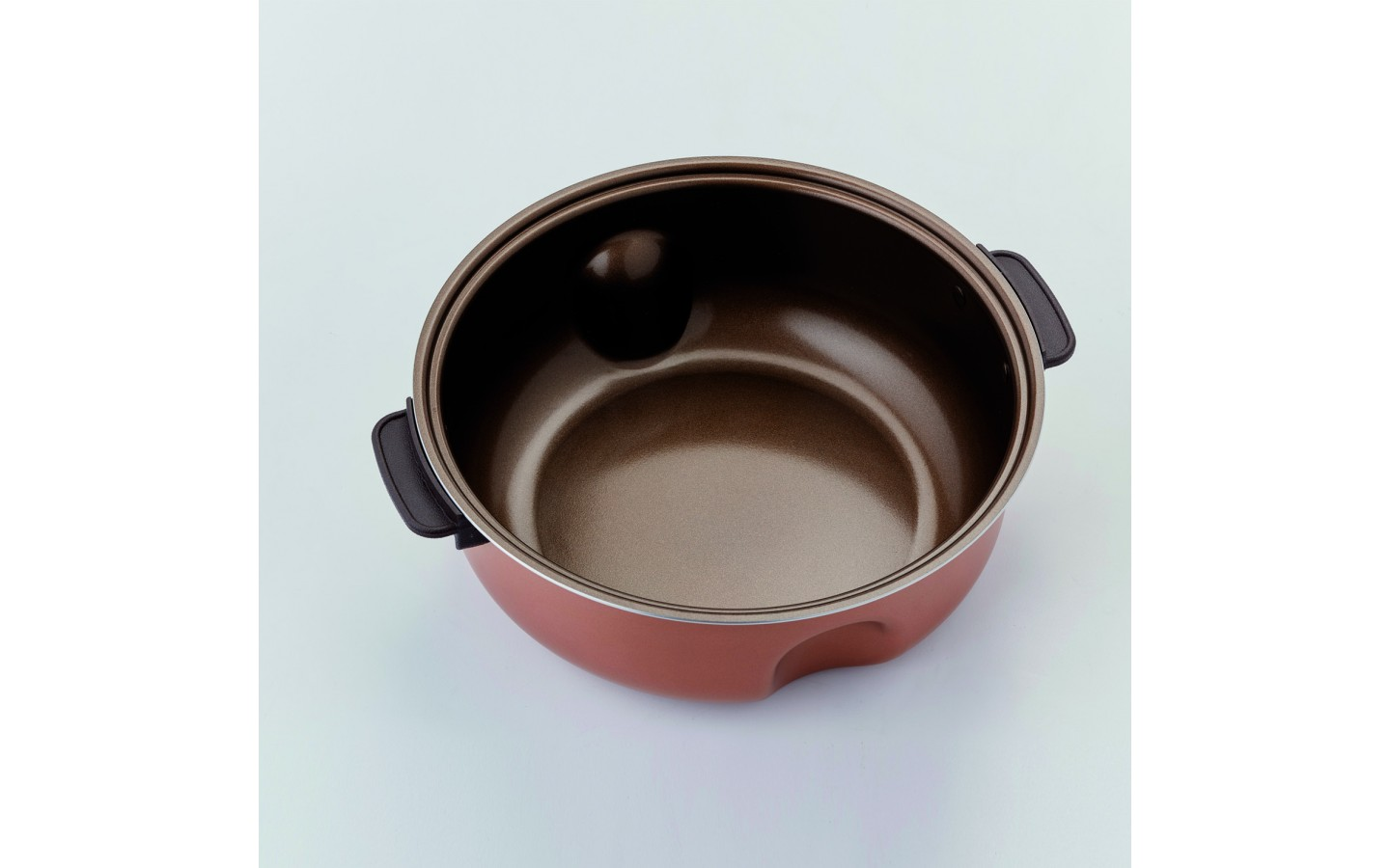 Czerwony i brązowy garnek, widok z góry.