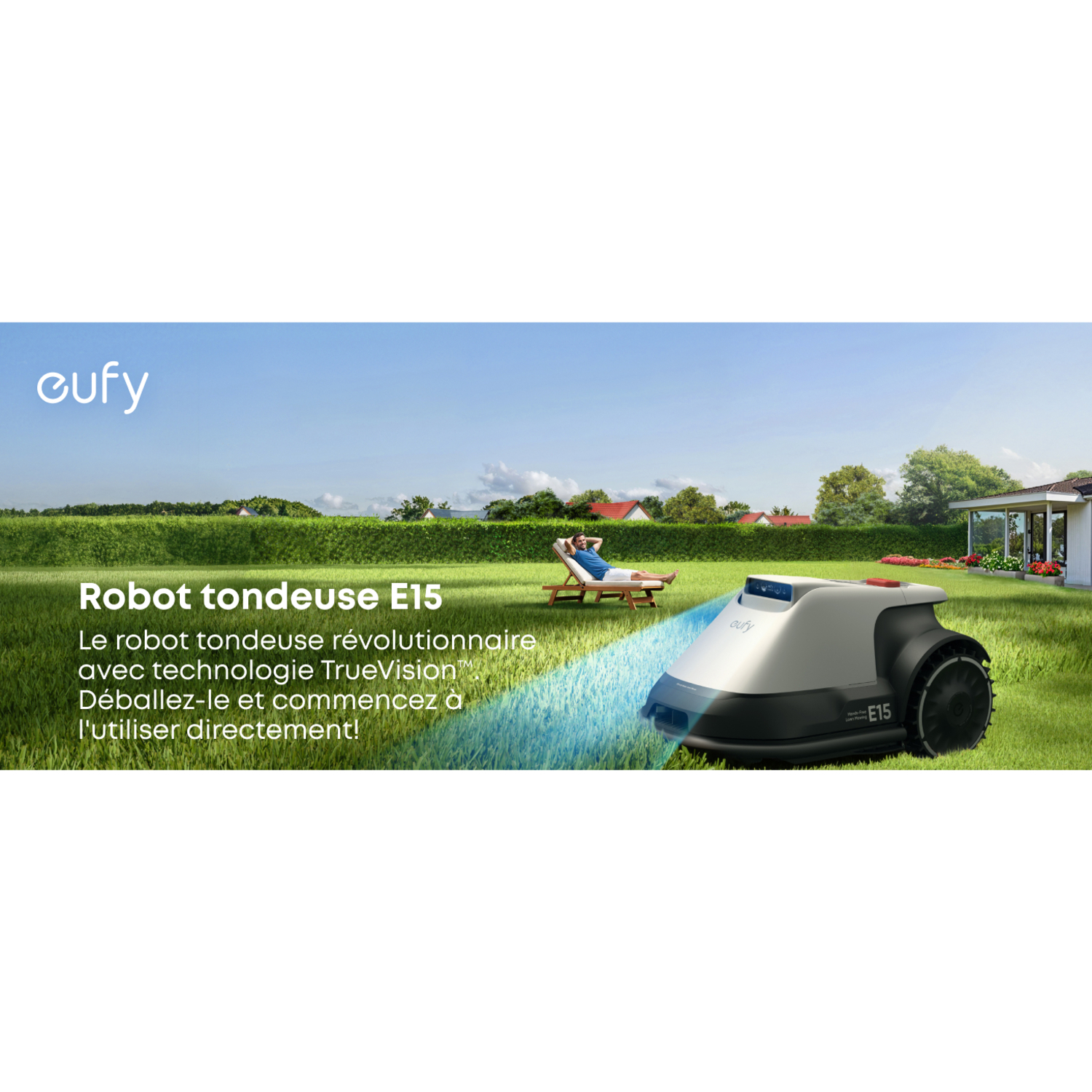 Une tondeuse robot dans un jardin vert. Un homme est allongé dans une chaise en arrière-plan.