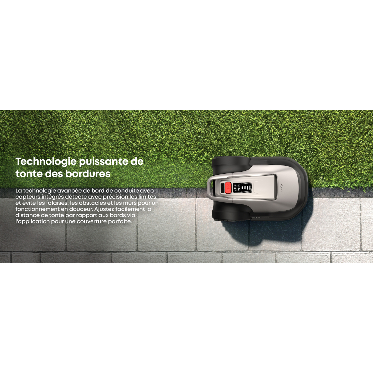 Robot tondeuse sur briques grises à côté d'herbe verte. Texte en français.