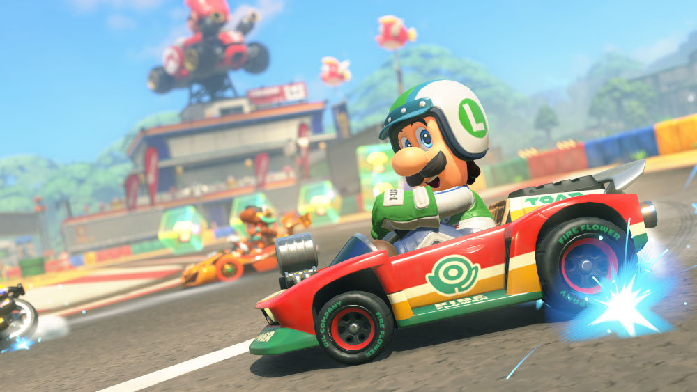 Luigi in een rode kart racet op een baan in een Mario Kart spel.