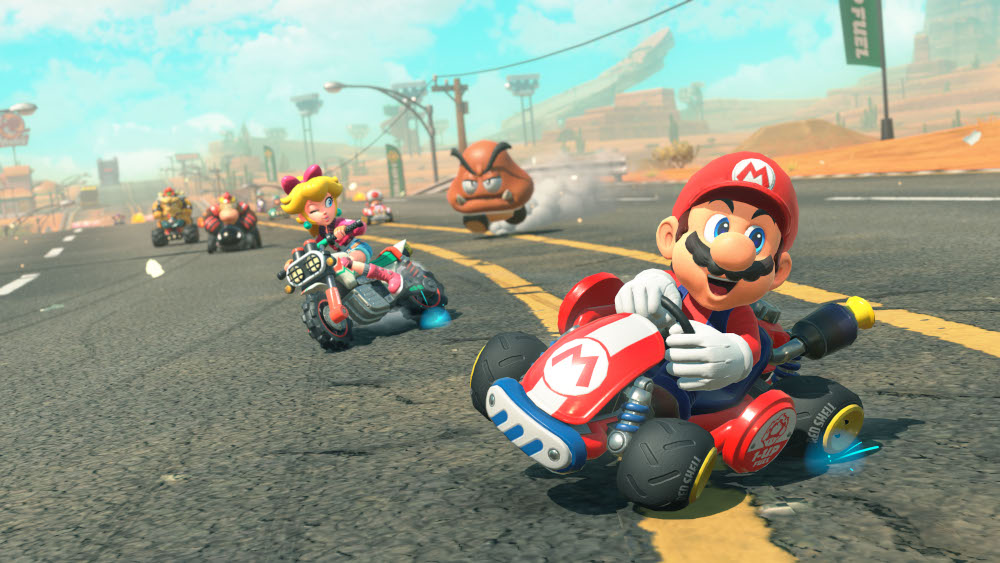 Mario in een rode kart leidt een race tegen andere racers.
