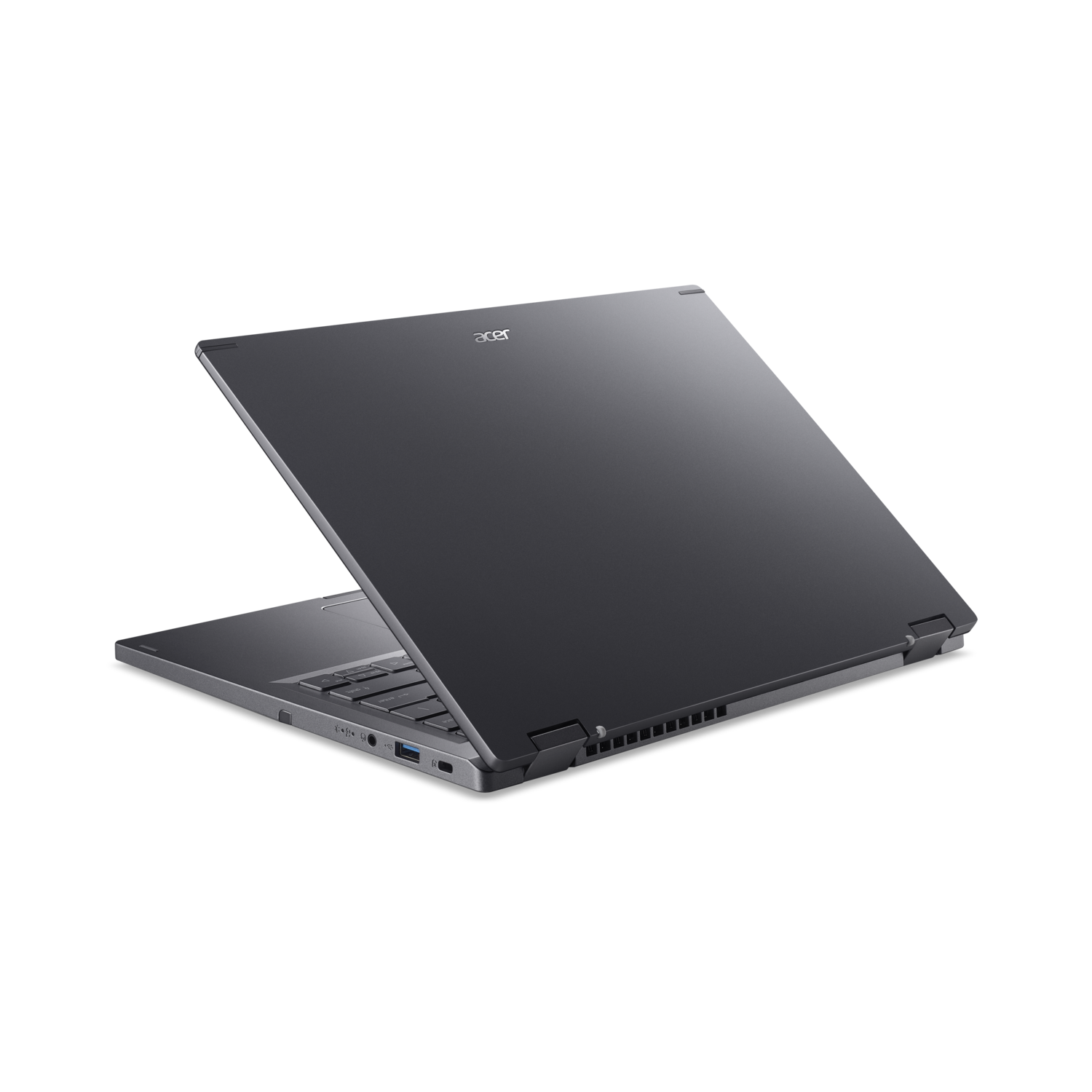 Dark gray laptop, open at an angle on a black surface.