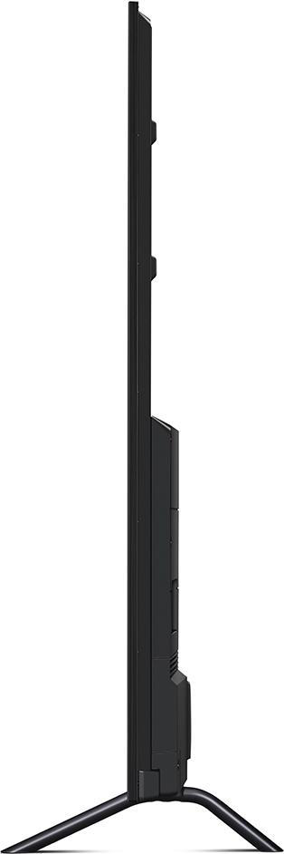 Seitenansicht eines schwarzen Fernsehers auf einem Ständer. Der Bildschirm ist dünn und die Basis hat ein gebogenes Design.