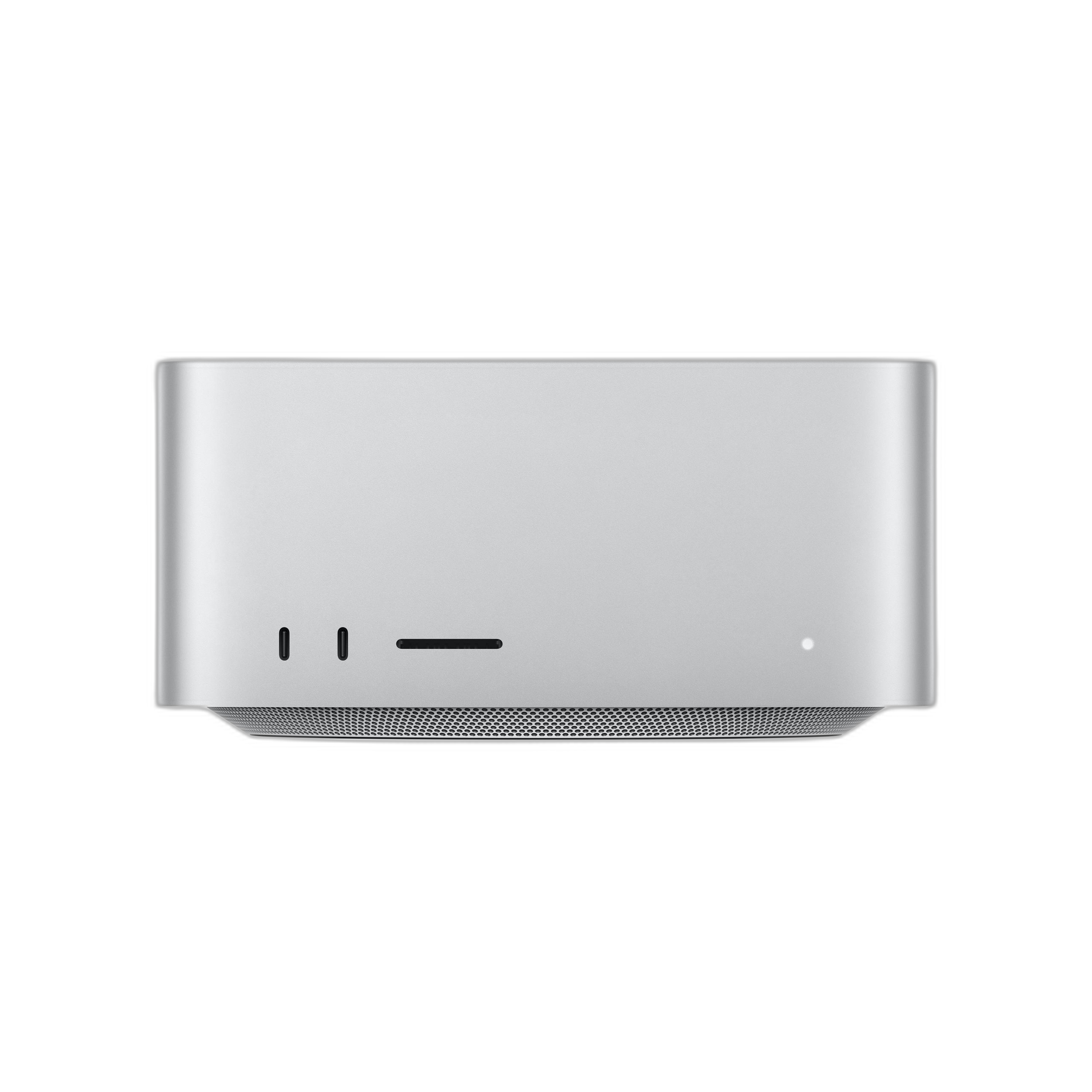 Un ordenador Mac Studio plateado con un pequeño panel frontal. Se encuentra sobre una superficie negra.