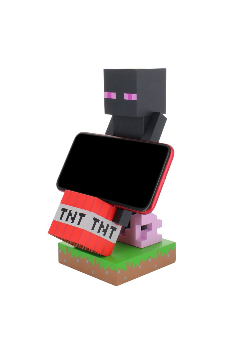 Minecraft Enderman-Figur mit Telefon, TNT-Block-Basis und rosa Schwein. Weißer Hintergrund.