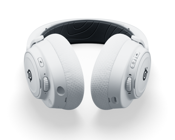 Białe słuchawki do gier. Zbliżenie na słuchawki, pokazujące nauszniki i elementy sterujące.