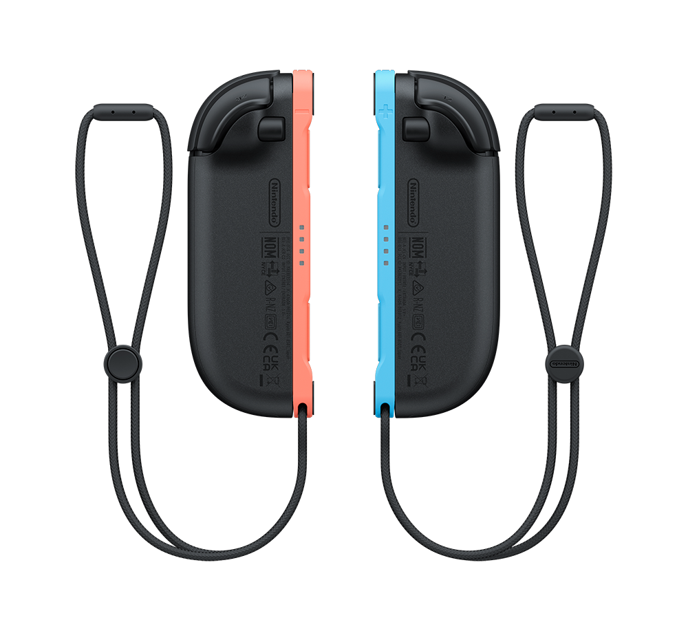Dos mandos Joy-Con de Nintendo Switch, uno rojo y otro azul, sobre negro.