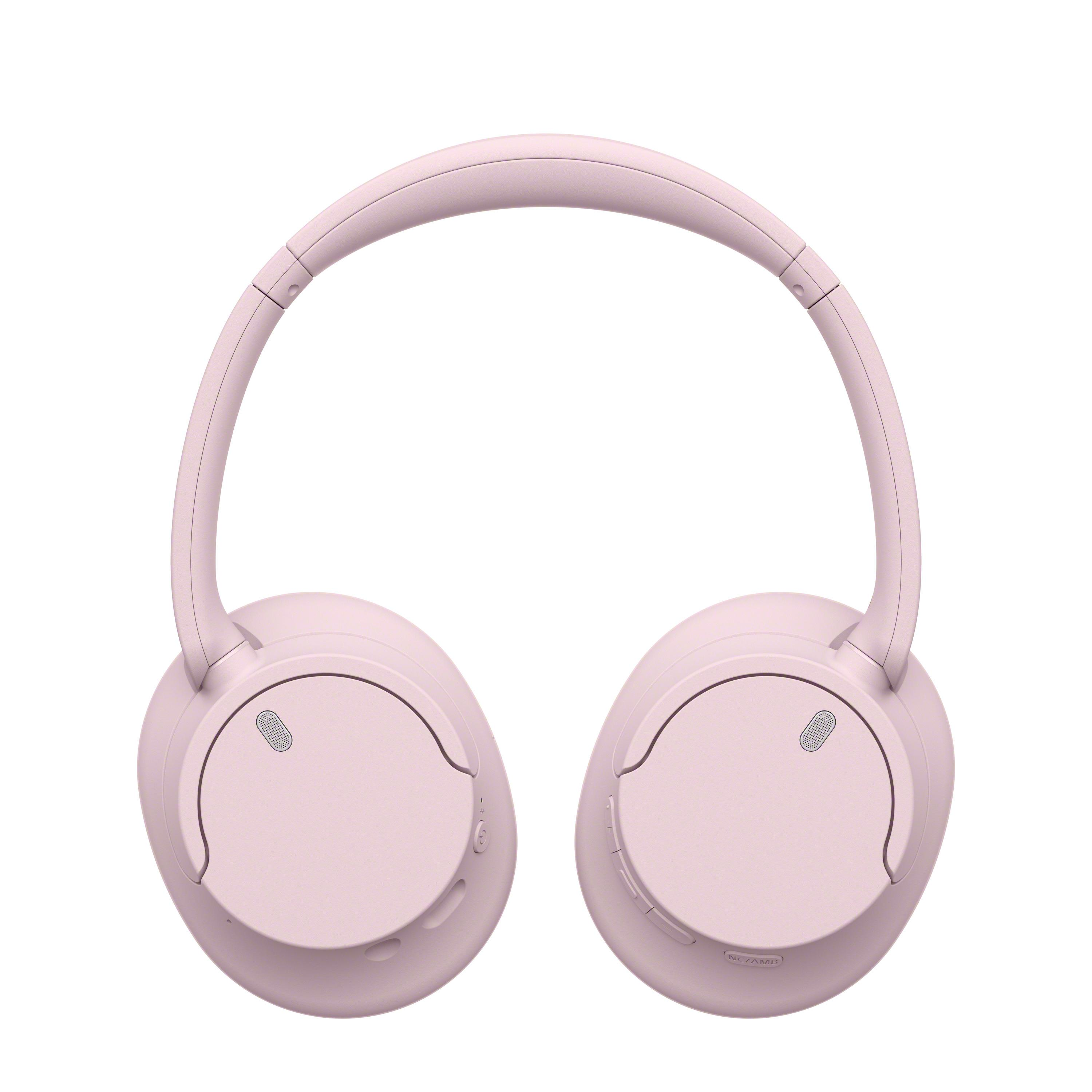 Różowe bezprzewodowe słuchawki nauszne na białym tle, widok z przodu.