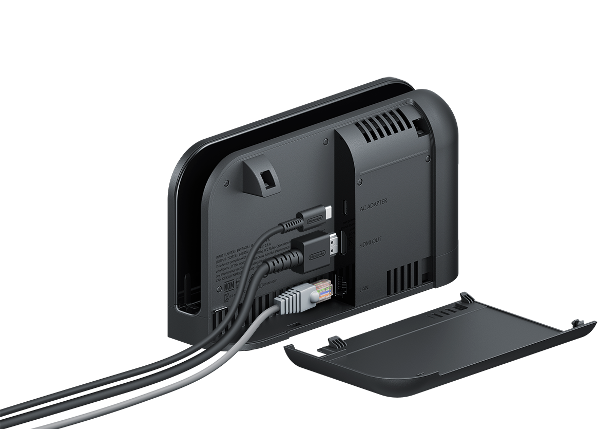 Base negra de Nintendo Switch. Cables enchufados. Puertos HDMI, adaptador de CA y LAN visibles. Tapa abierta a la derecha.