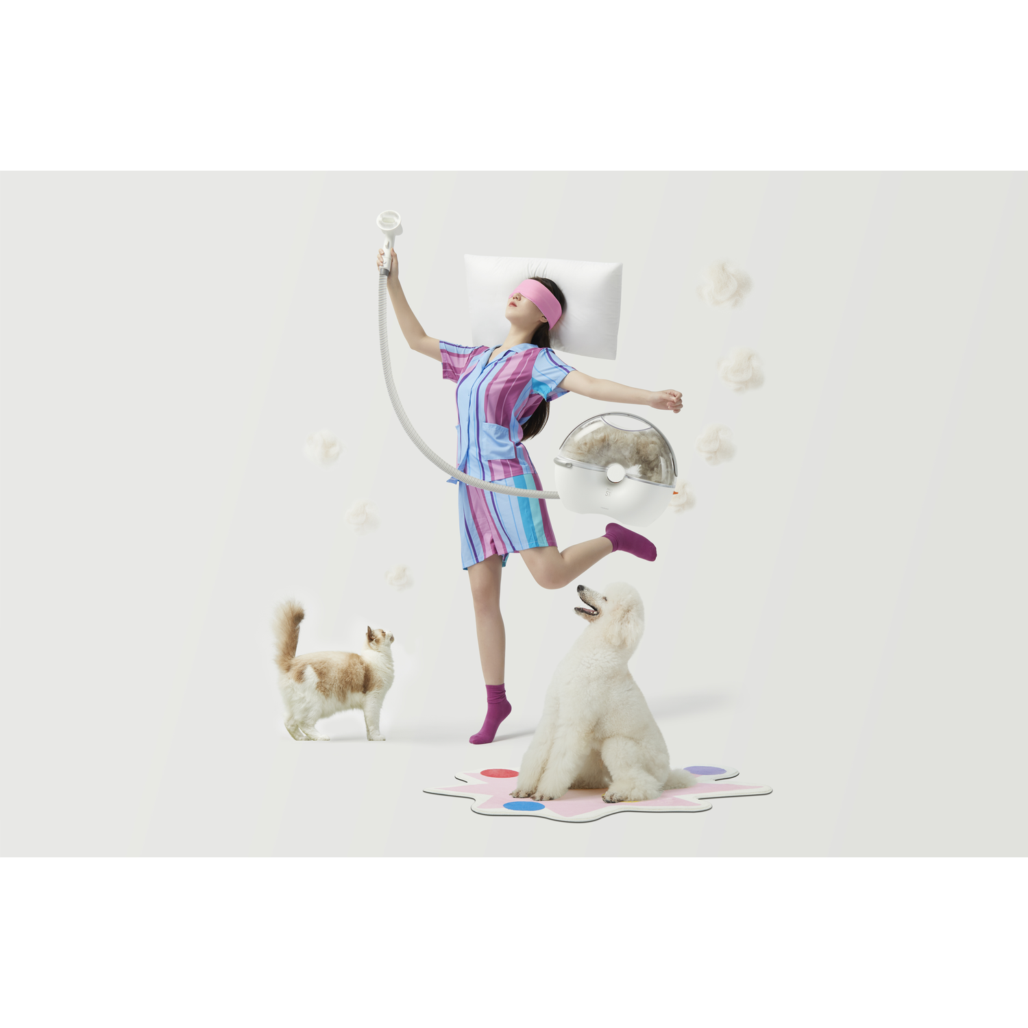 A woman with a pet care device and pets.