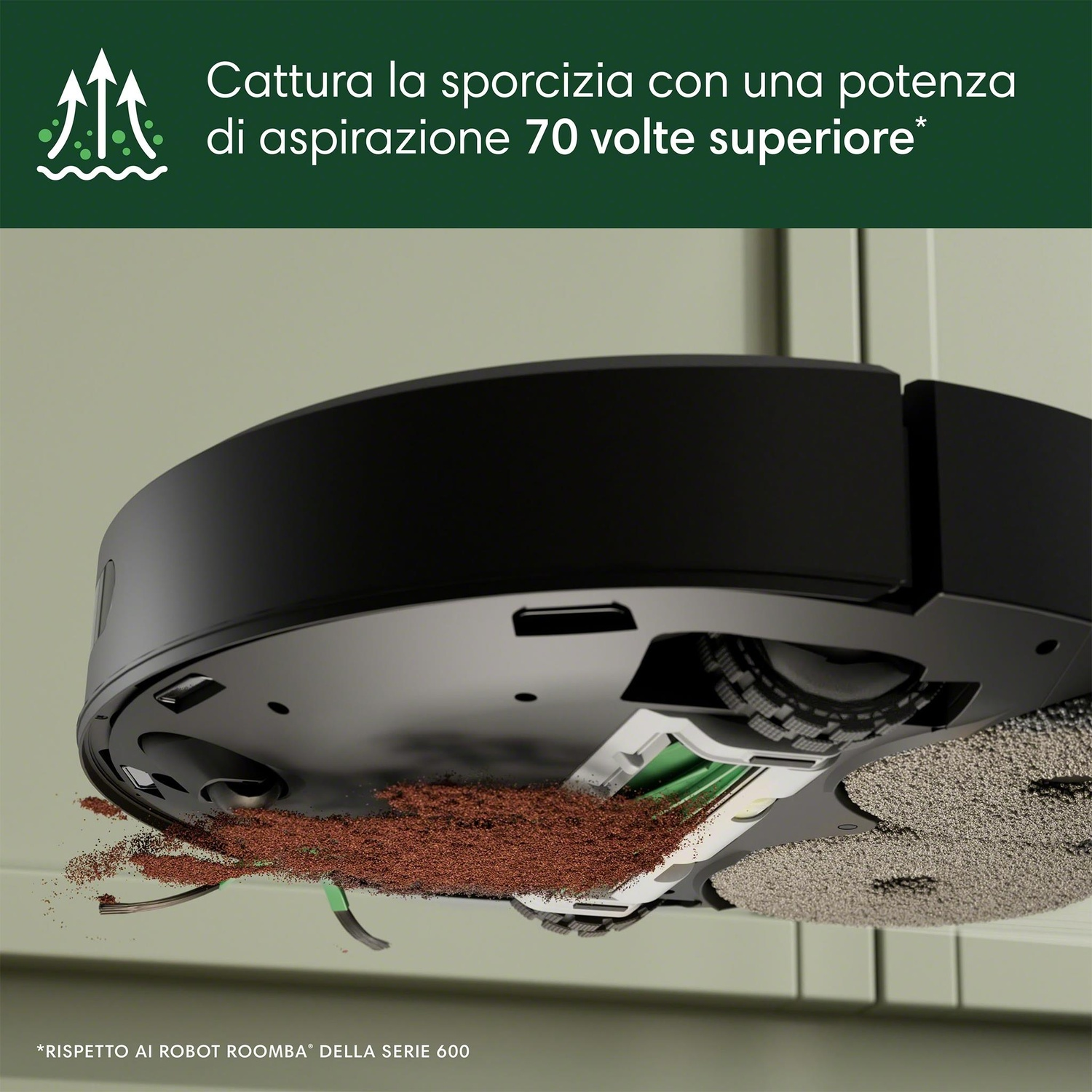 Aspirapolvere robot nero che pulisce detriti marroni. Spazzola verde visibile.