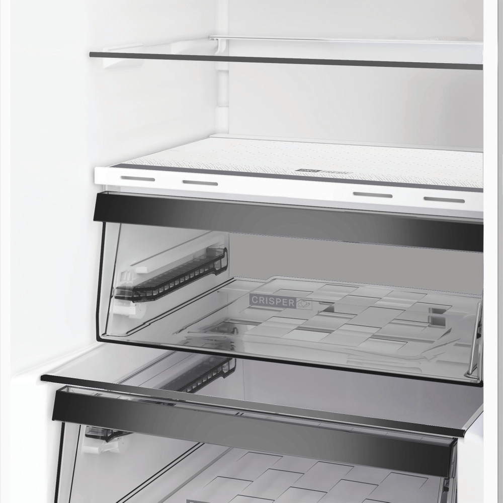 Un refrigerador abierto con alimentos frescos en los cajones.
