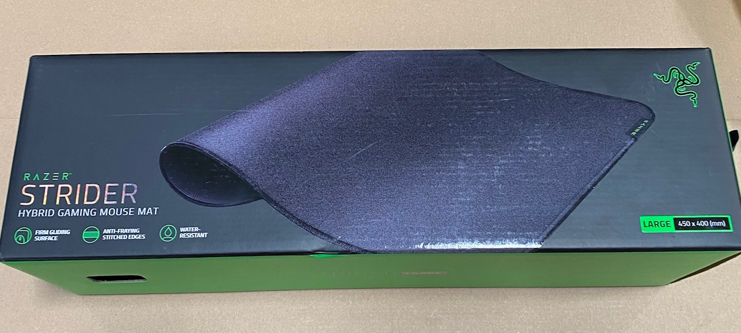 Podkładka pod mysz Razer Strider w pudełku. Tekst na pudełku zawiera 'Hybrid Gaming Mouse Mat'.