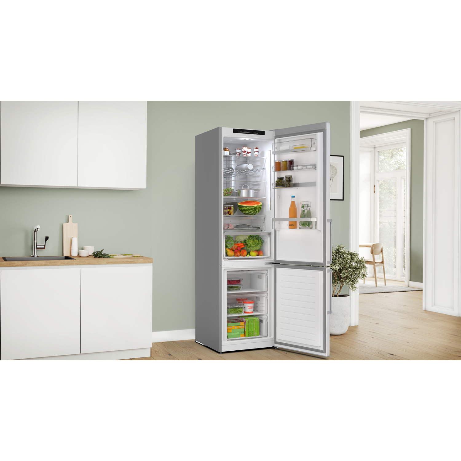 Open refrigerator with various food items inside, on a white wall.