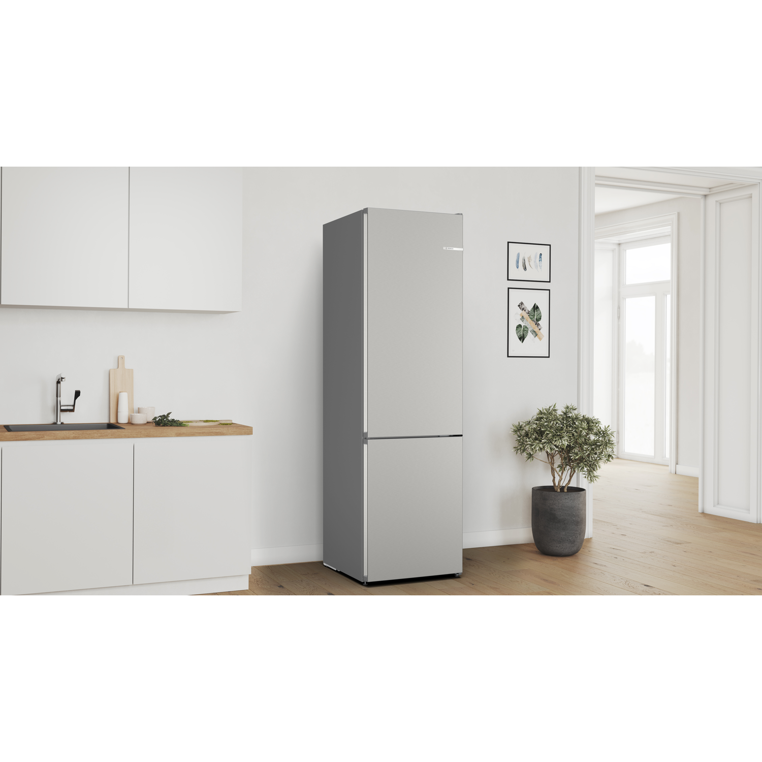 A modern kitchen with a silver refrigerator, a wooden countertop, and a potted plant. Bright, minimalist design.