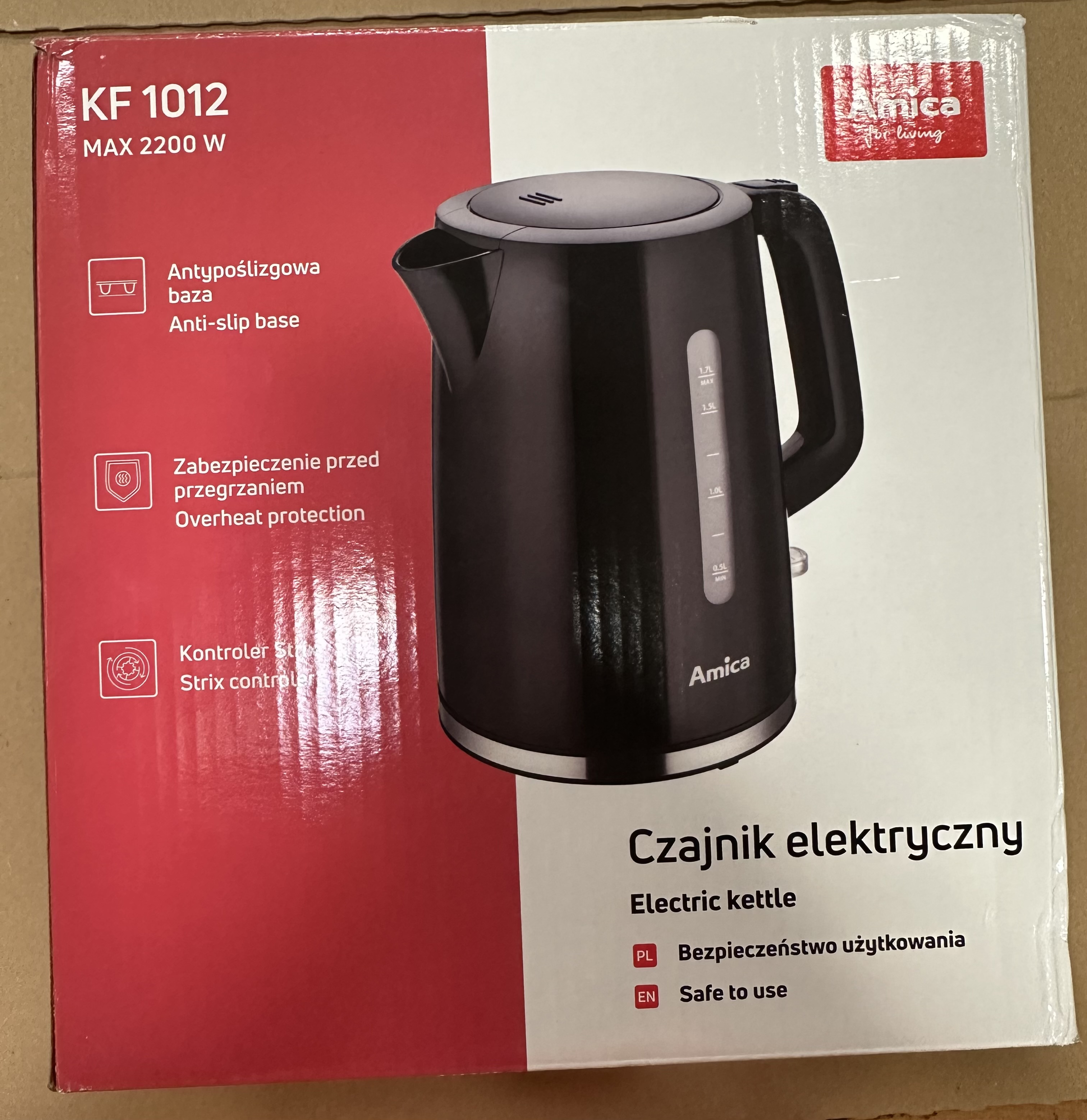 Czajnik elektryczny na pudełku, z ikonami bezpieczeństwa i antypoślizgowości.