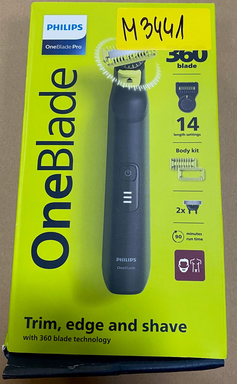 Opakowanie Philips OneBlade Pro z trymerem i golarką, żółte i zielone.