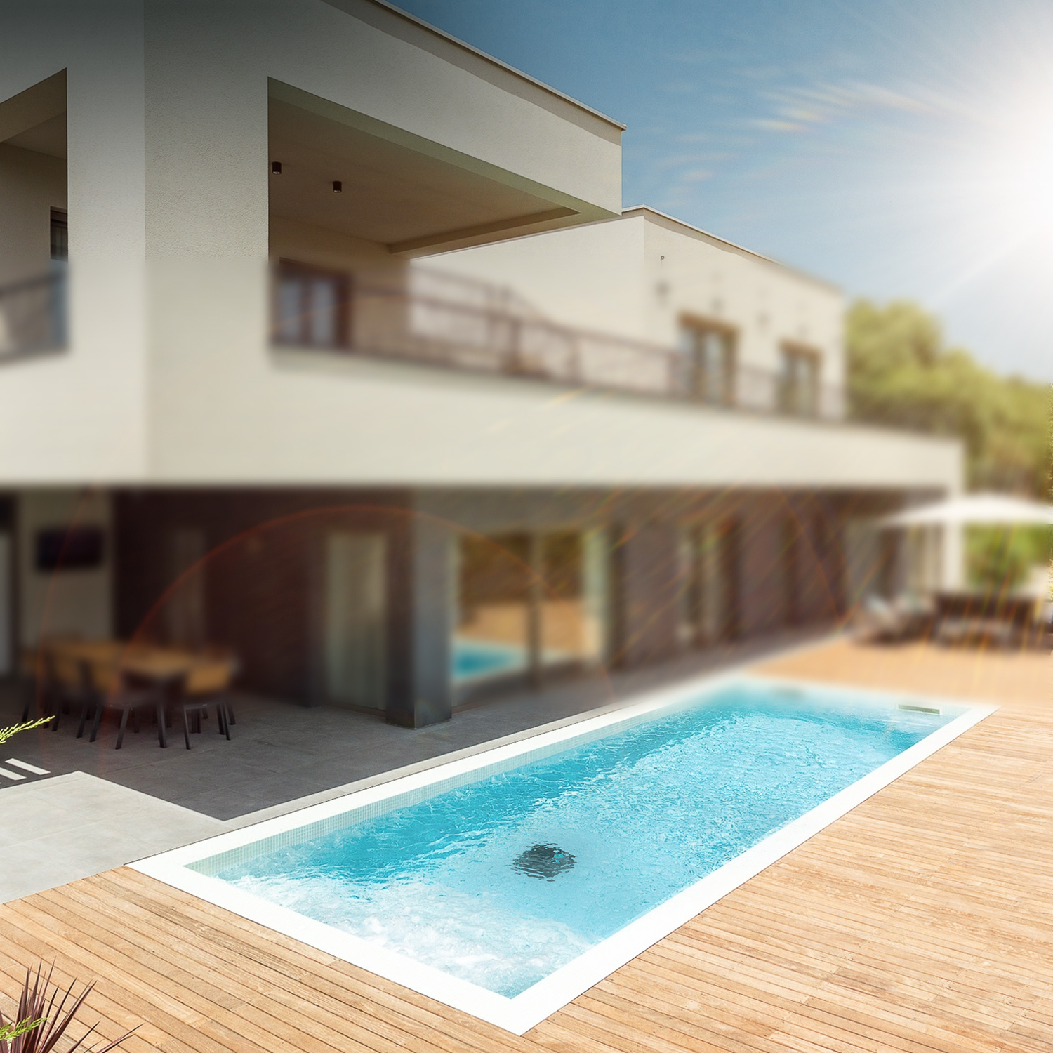 A modern house with a pool and wooden deck, with a blurred background under a bright sun.