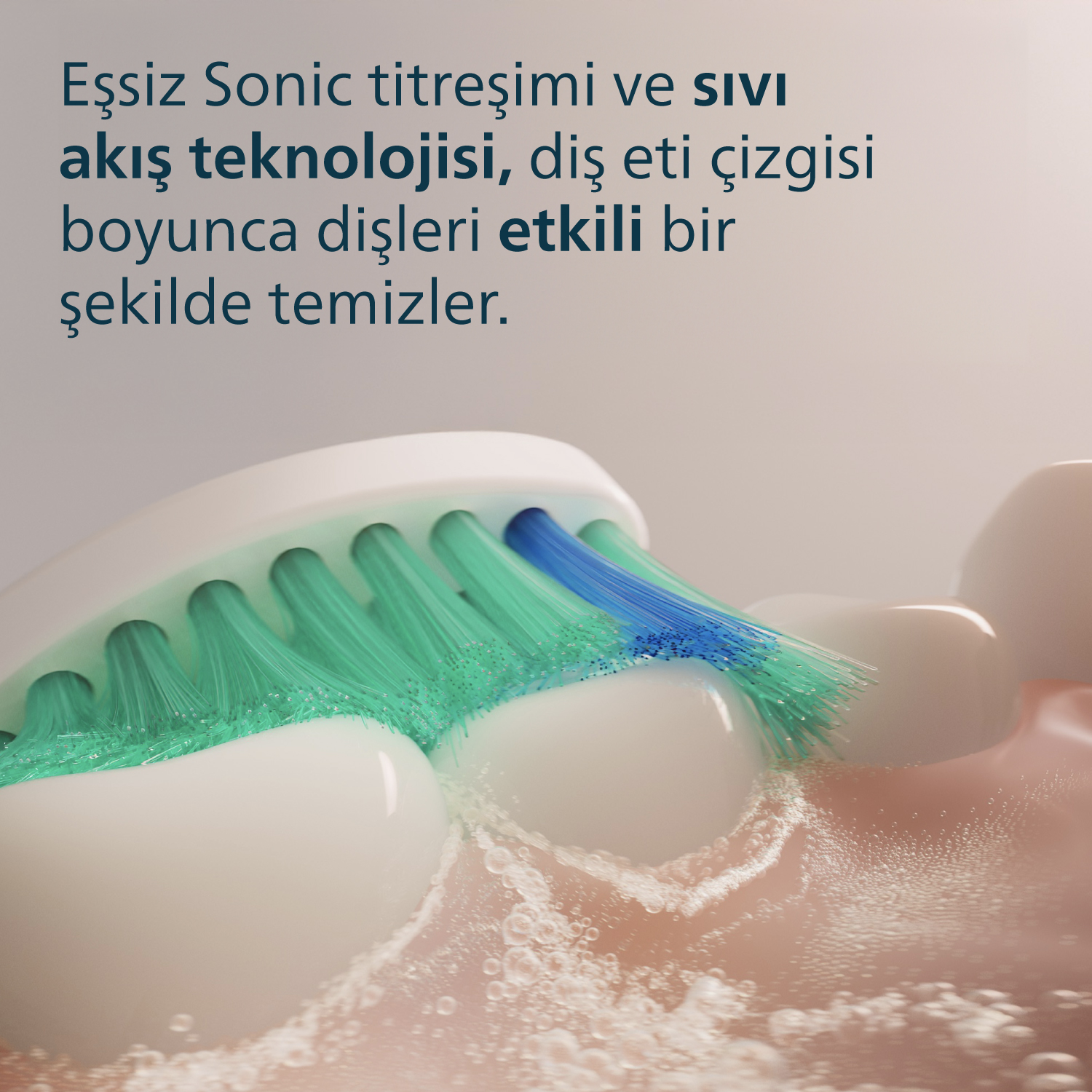 Dişleri temizleyen diş fırçasının yakın çekimi. Yeşil ve mavi kıllar, beyaz dişler. Su ve köpük görünür. Pembe diş etleri.