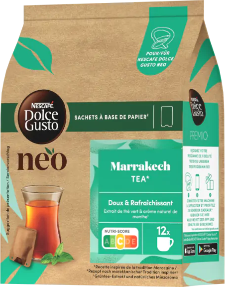 Busta di carta marrone con etichetta verde e tazza di tè a sinistra.