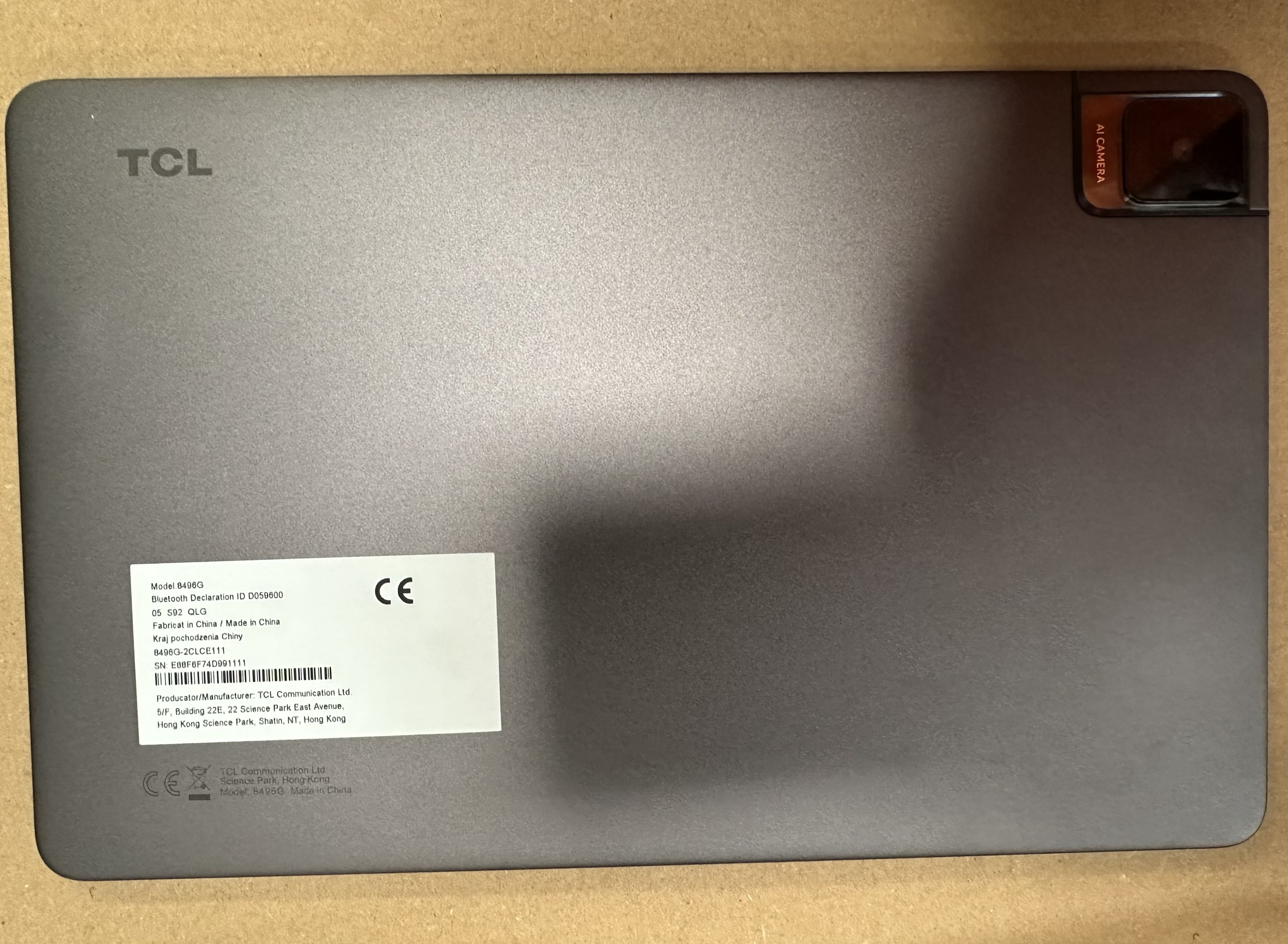 Tył ciemnoszarego tabletu z aparatem i logo TCL.