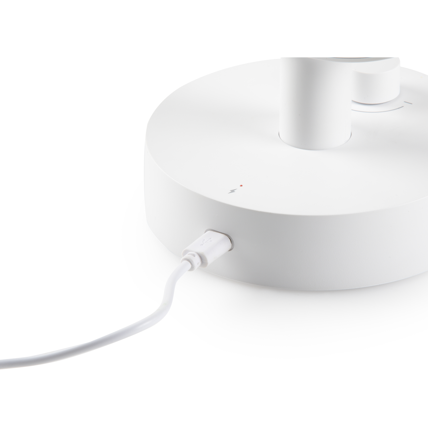White charging base with a cable plugged in. White background.