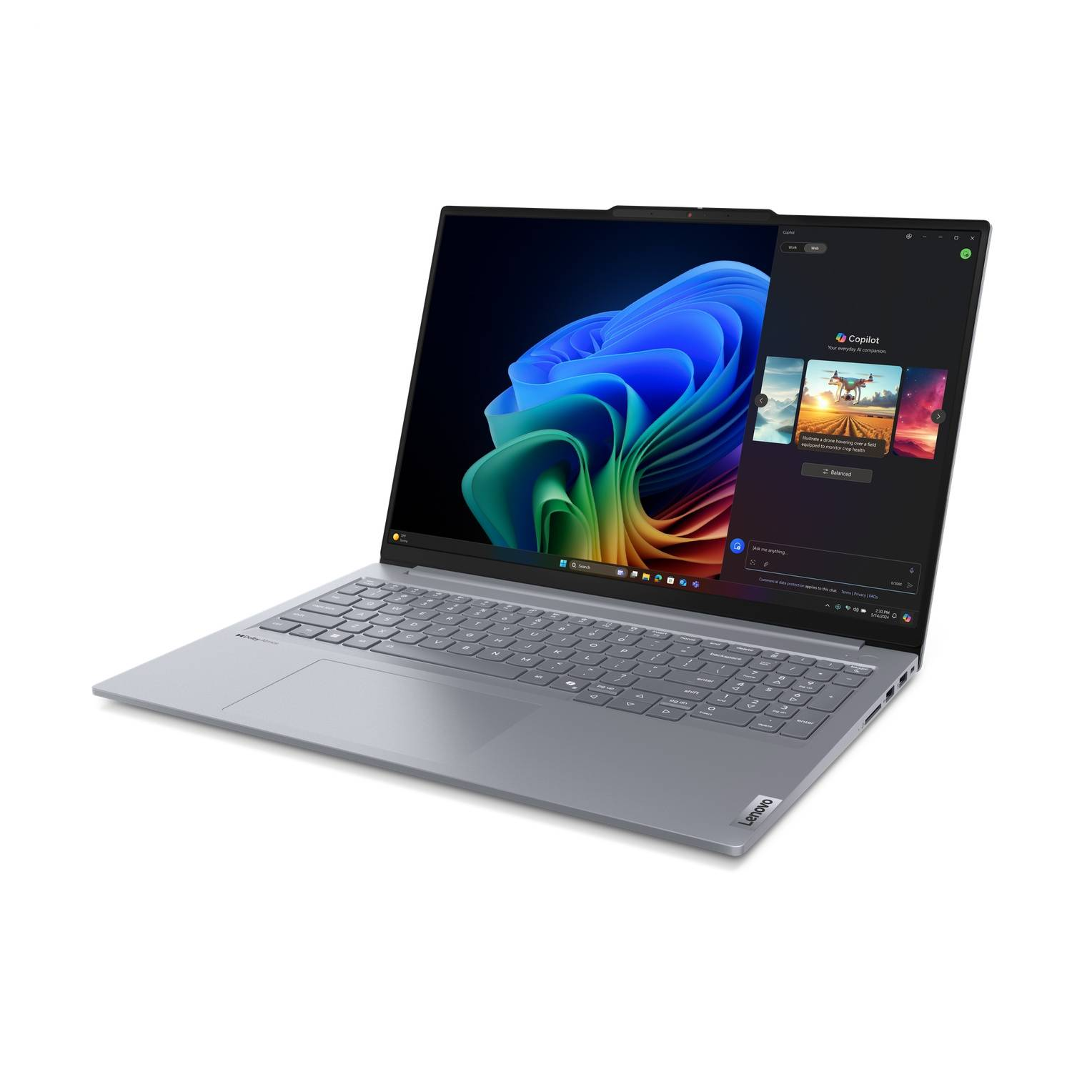 A silver laptop with a dark screen showing a colorful image and a Copilot window.