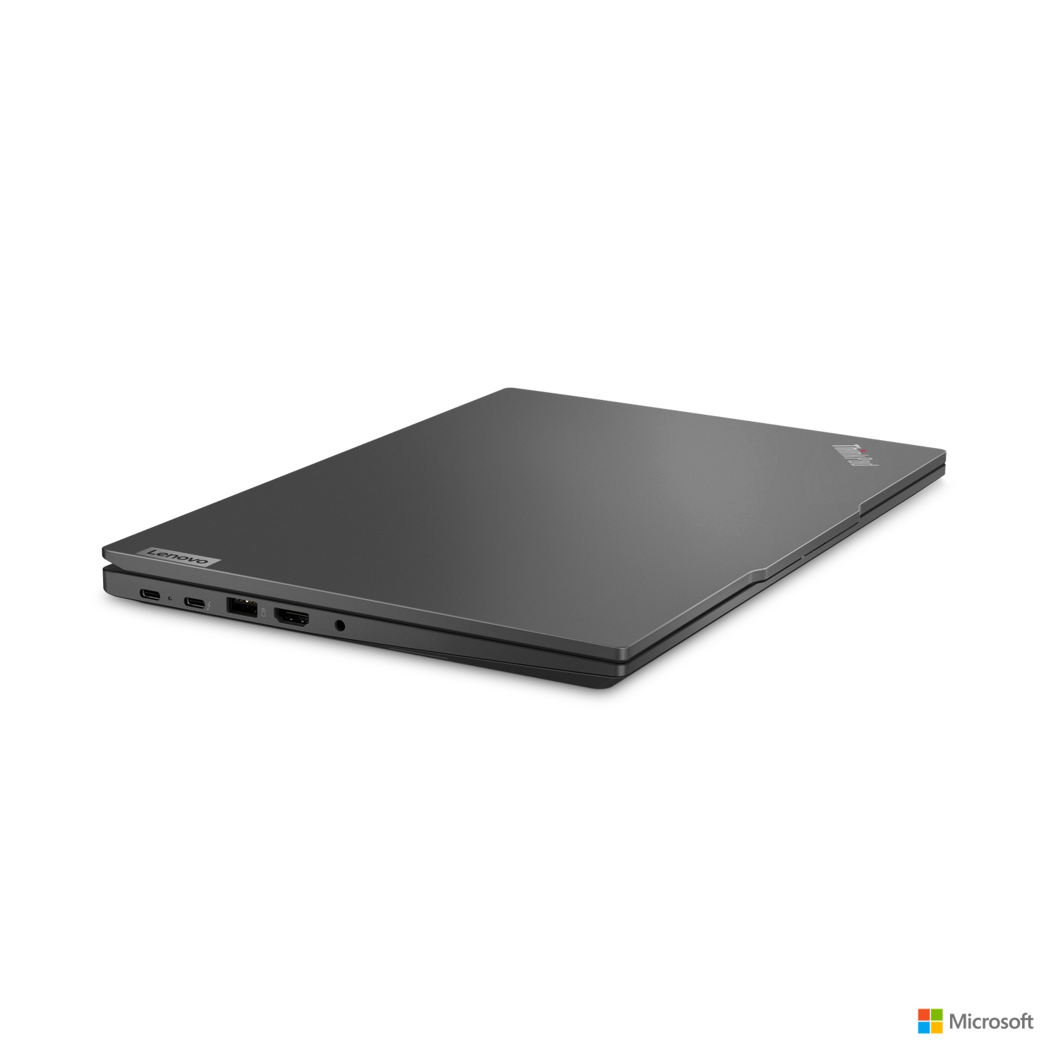 Closed dark gray Lenovo ThinkPad laptop on a white surface, with Microsoft logo in the corner.