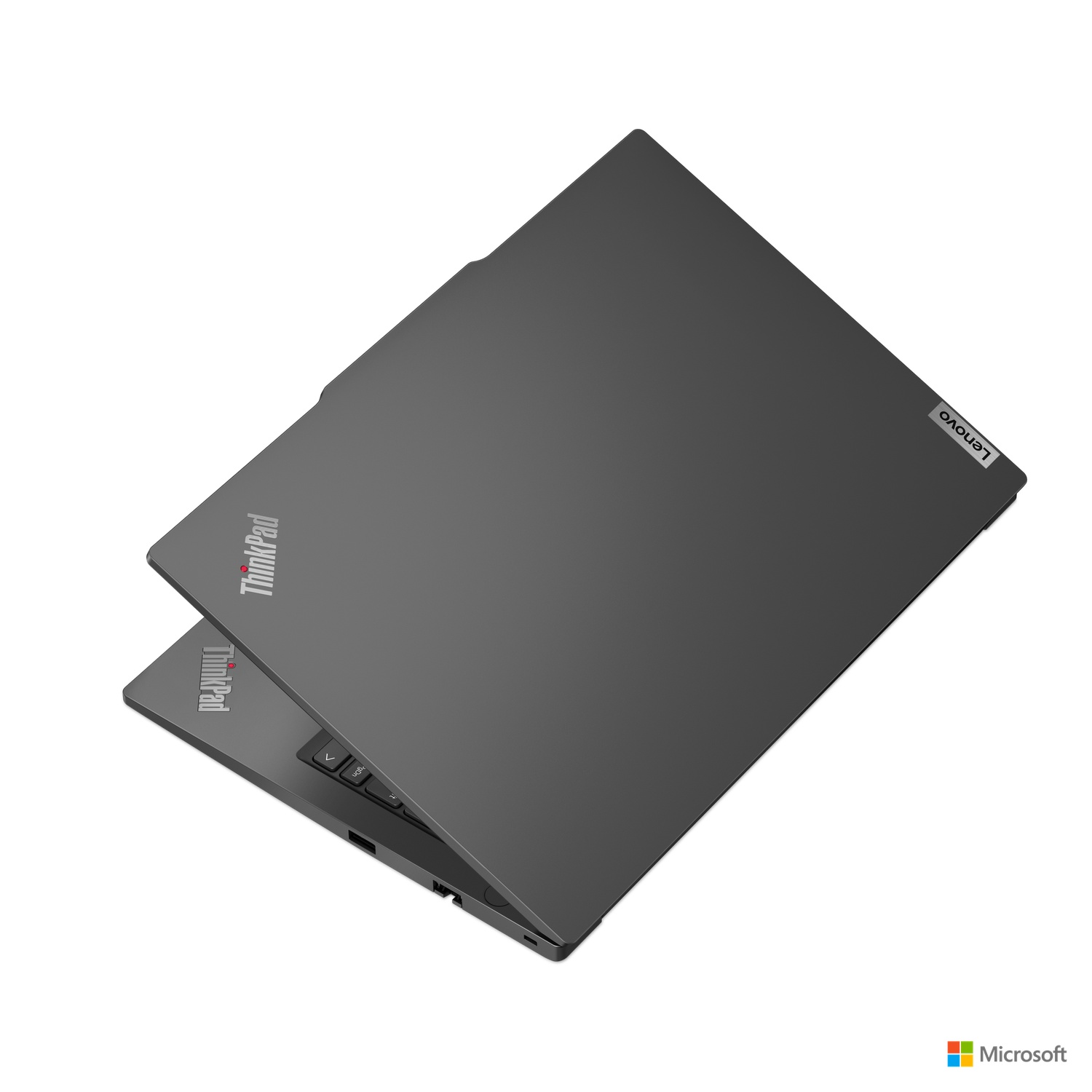 A dark gray Lenovo ThinkPad laptop, slightly open. It's on a white surface, with the Lenovo logo.